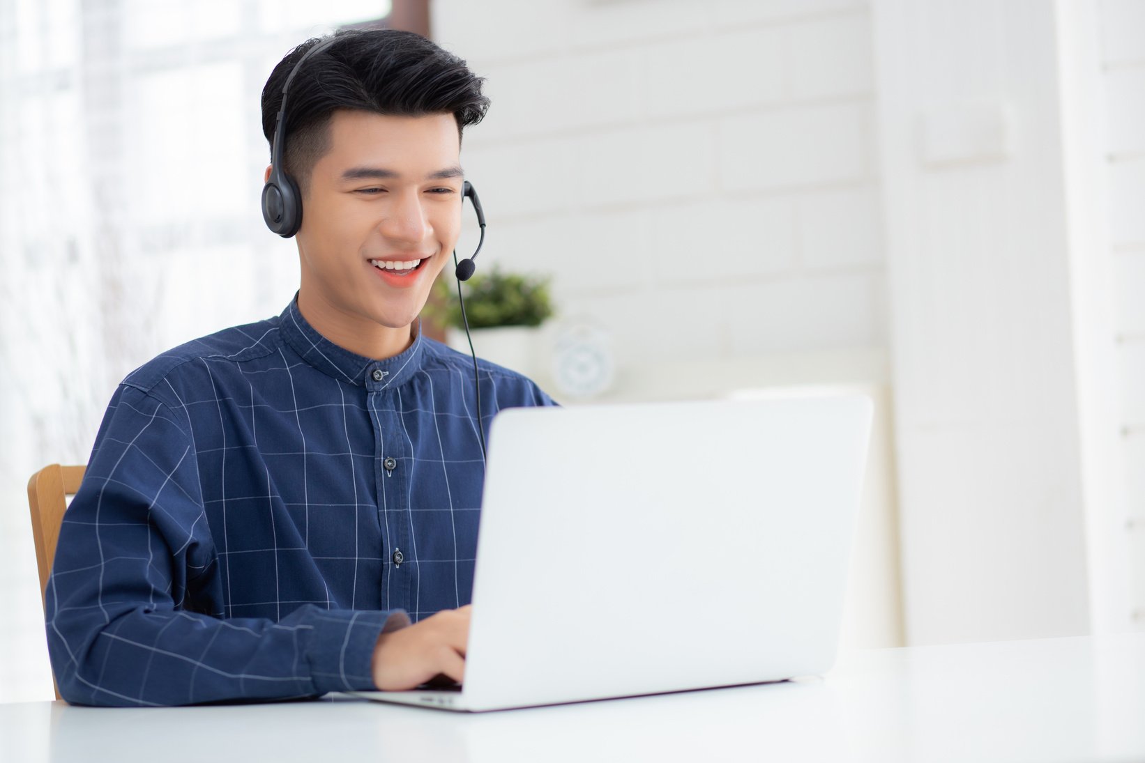  Businessman Working on Laptop Wearing Headphones 